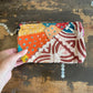 Colourful patchwork purse on a wooden surface