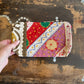 Colourful patchwork purse on a wooden surface