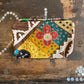 Colourful patchwork purse on a wooden surface