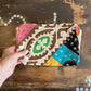 Colourful patchwork purse on a wooden surface