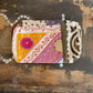 Colourful patchwork purse on a wooden surface